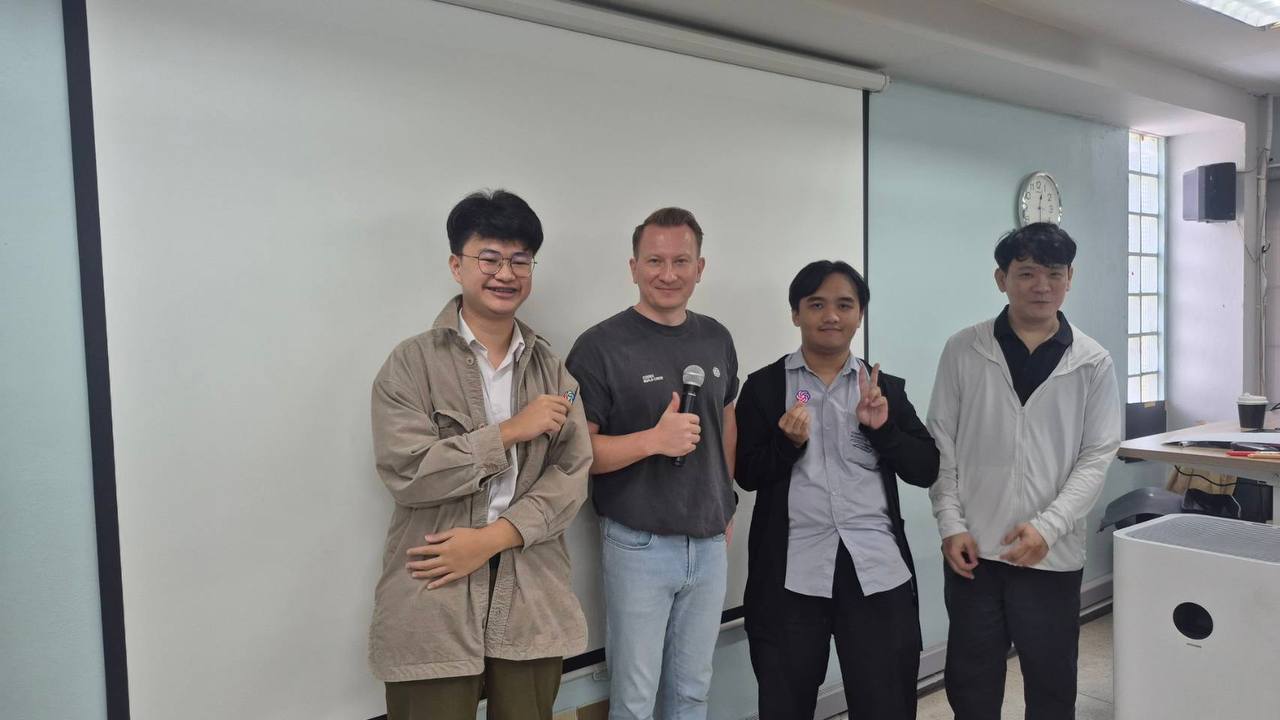 Vladislav Guzey and three students posing at the front of the CMU workshop room