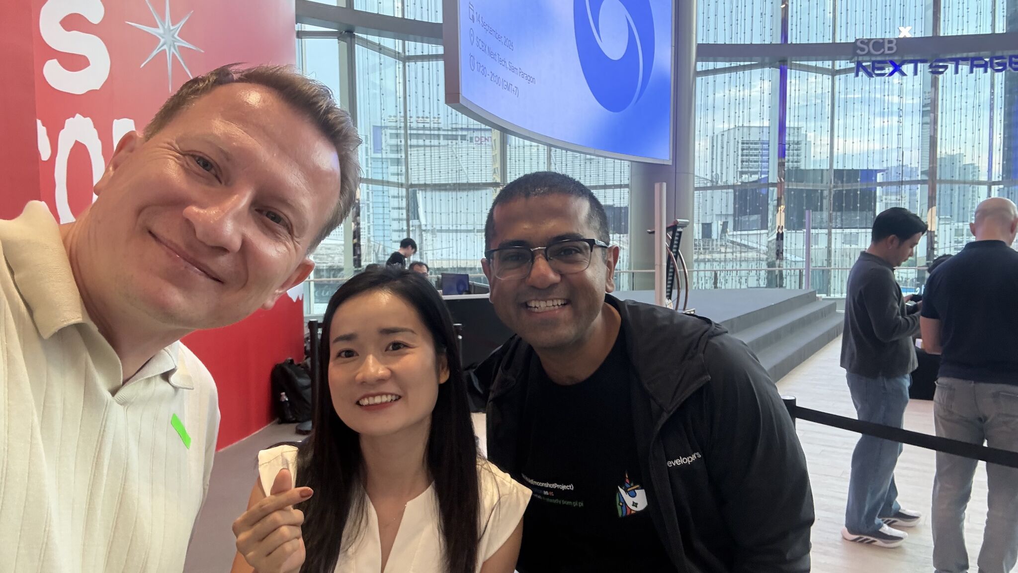 A community selfie with three attendees at SCBX NEXT TECH during the DeepMind meetup in Bangkok
