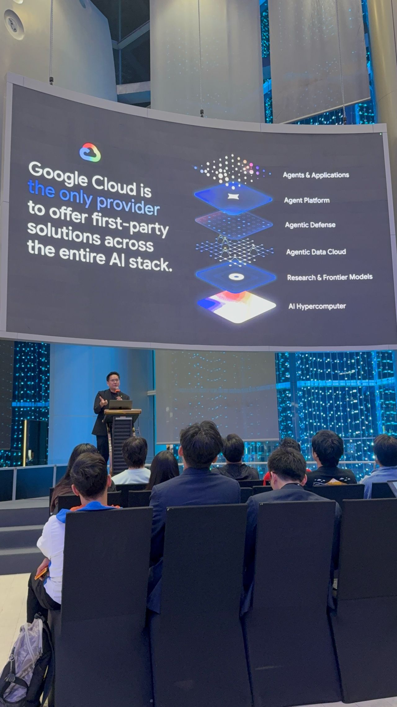 A Google Cloud presentation showing layers for infrastructure, models, data, defence, agent platforms, and applications